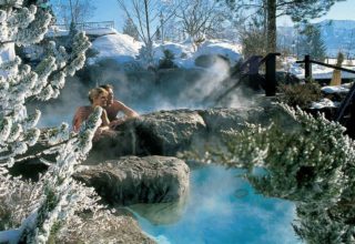 Couple on a steamy outdoor hot tub on a winter day