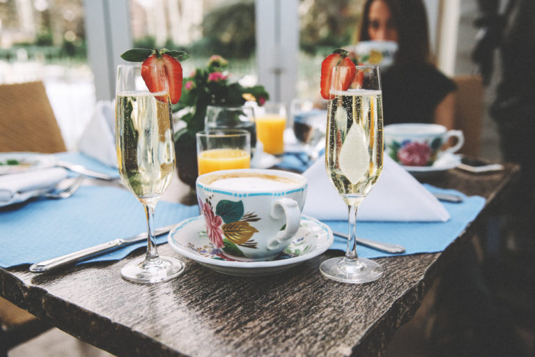 Cup of hot chocolate and champagne glasses on table