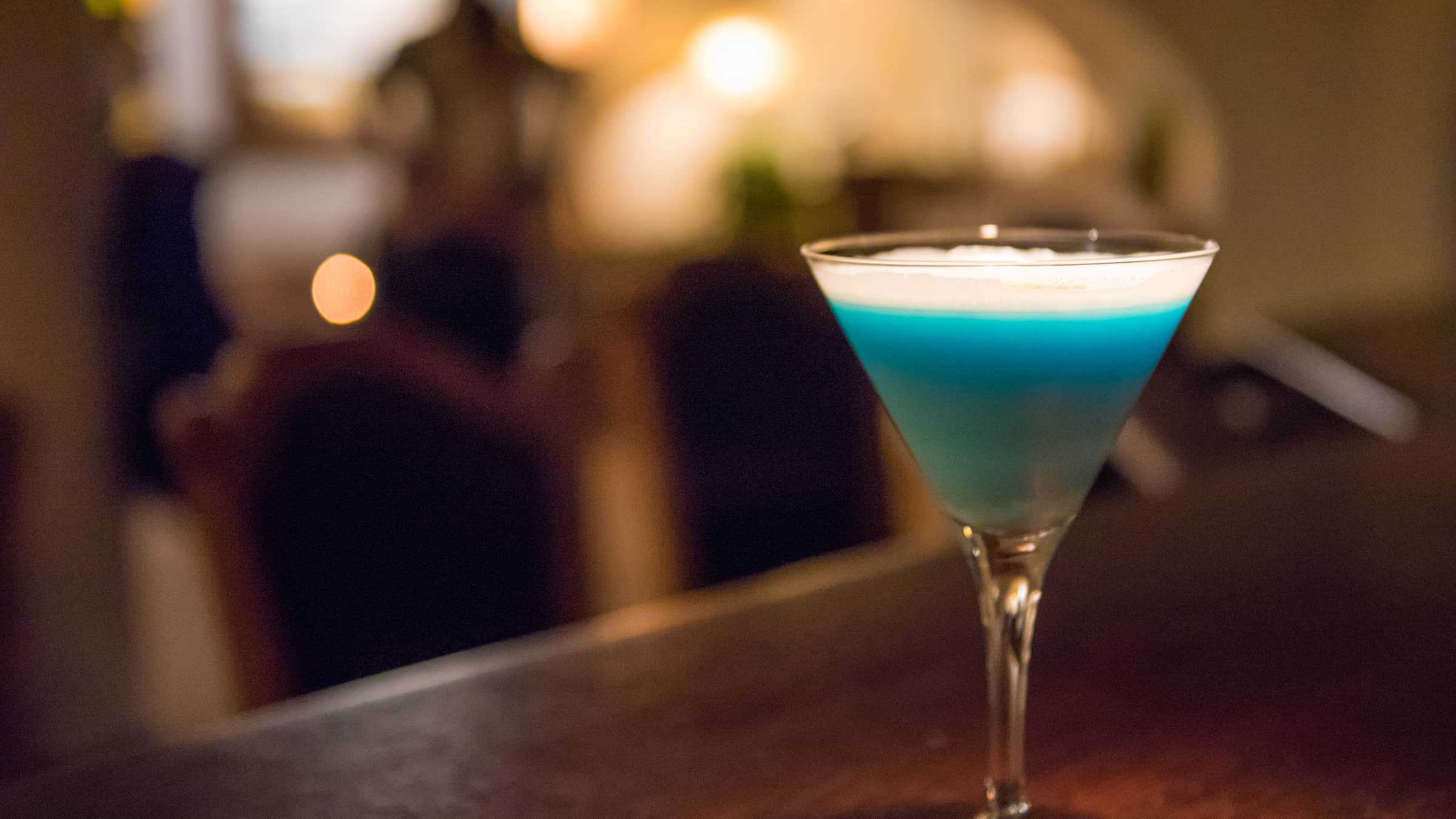Closeup of blue cocktail drink on table