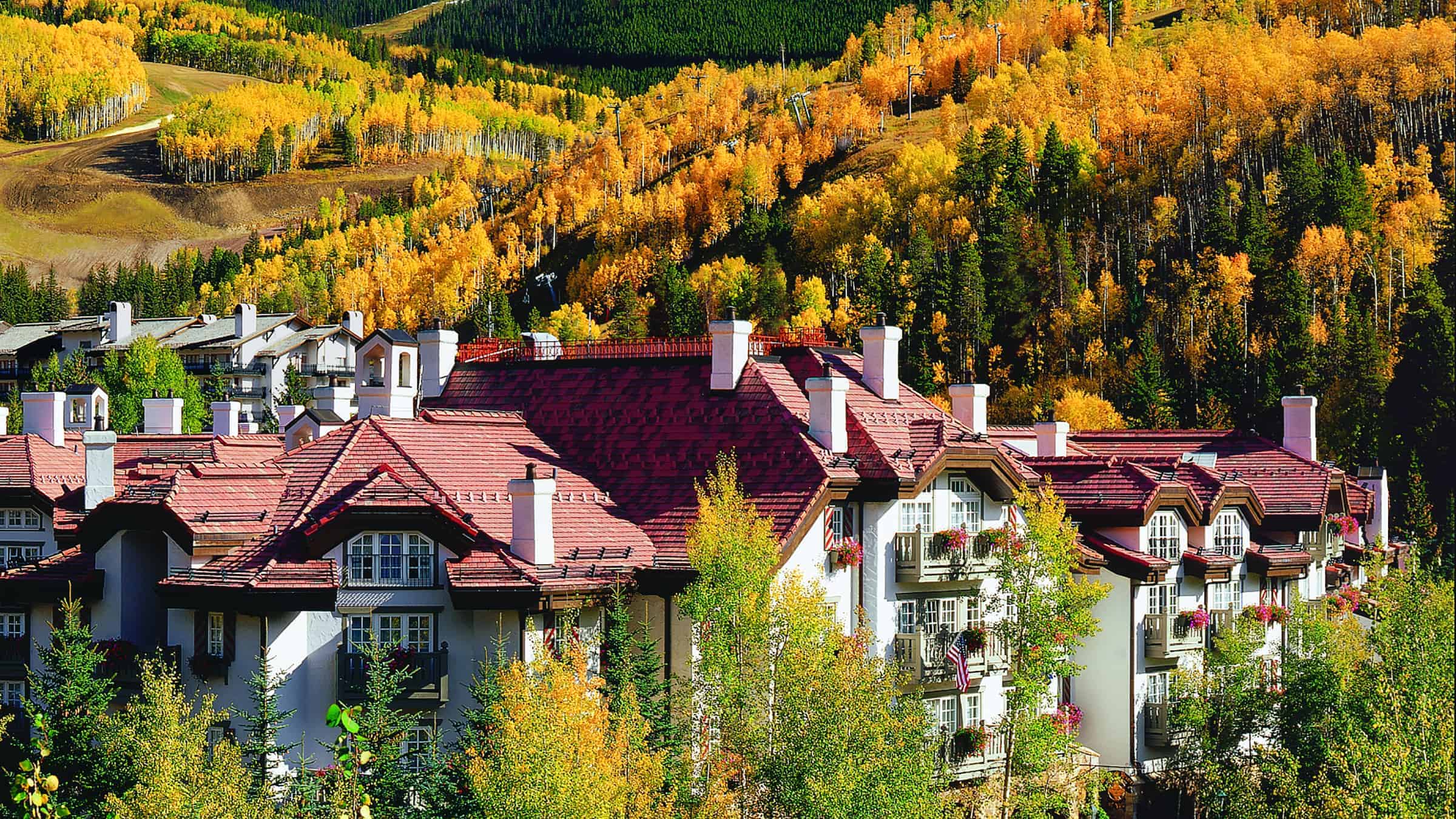 Sonnenalp Hotel surrounded by trees and fall foliage on nearby hills