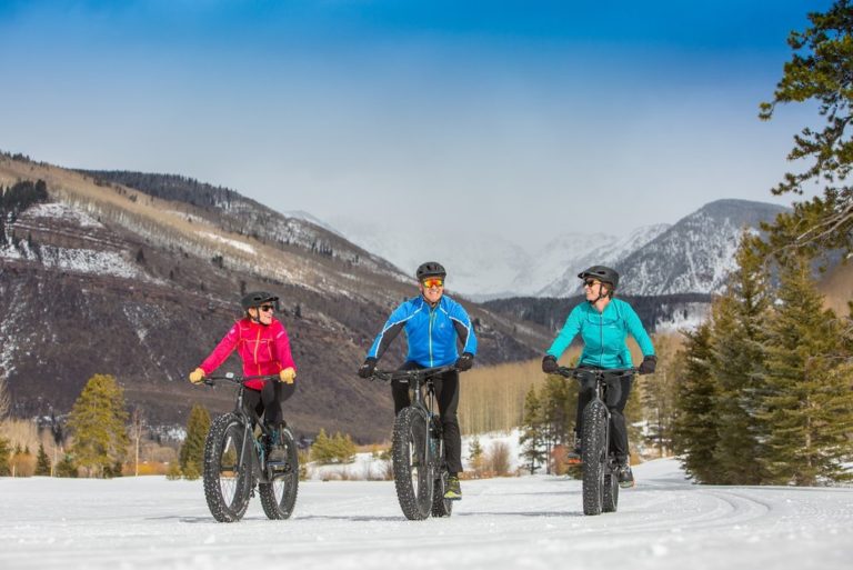 Three people on snow bycycles with fat tires