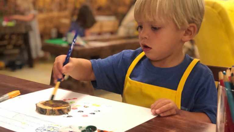 Child painting with brush