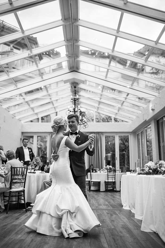 Bride and groom dancing at indoor reception area