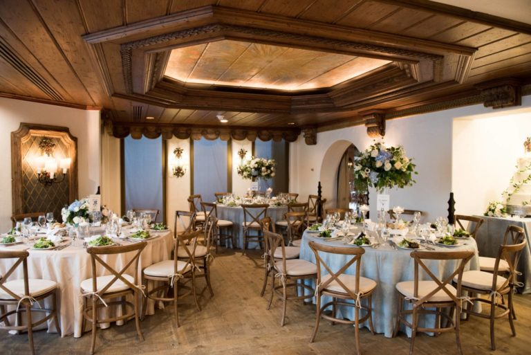 Reception area with tables with placesettings and centerpieces