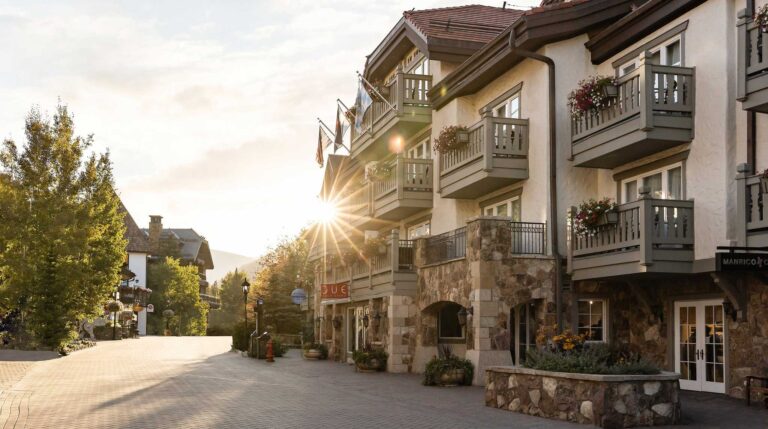 Sun shining behind the facade of Sonnenalp Hotel