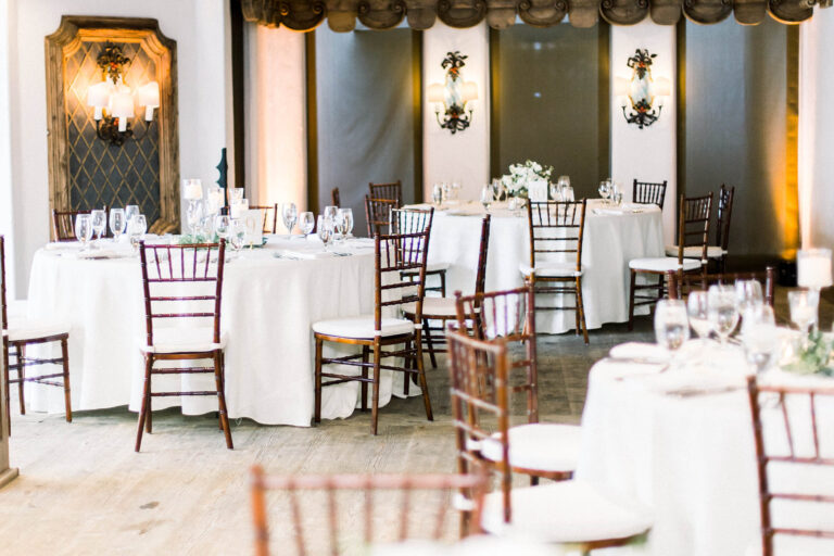 Reception area with tables, chairs, and placesettings