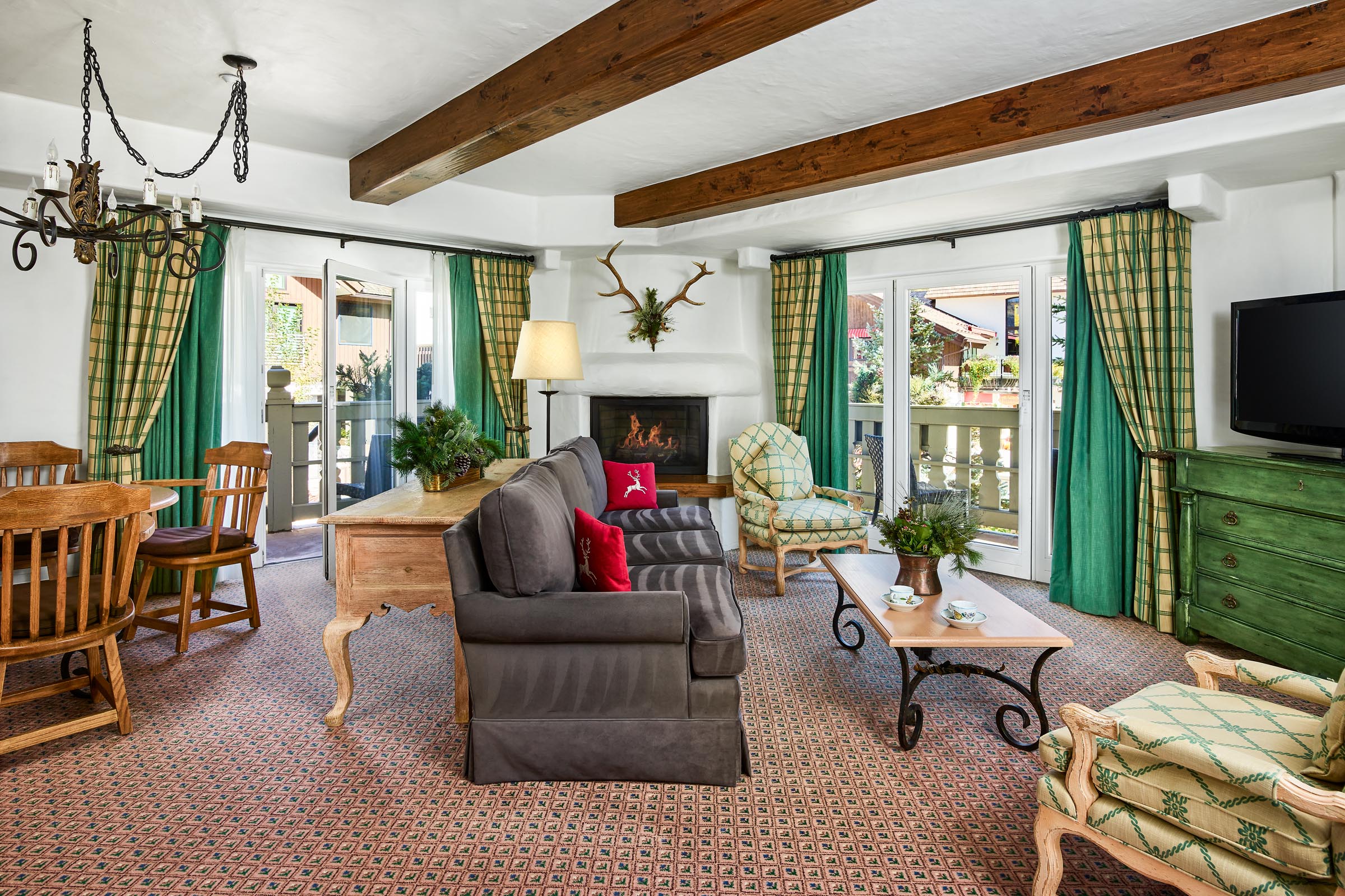Room with bed, fireplace, sofa, coffee table, and chairs