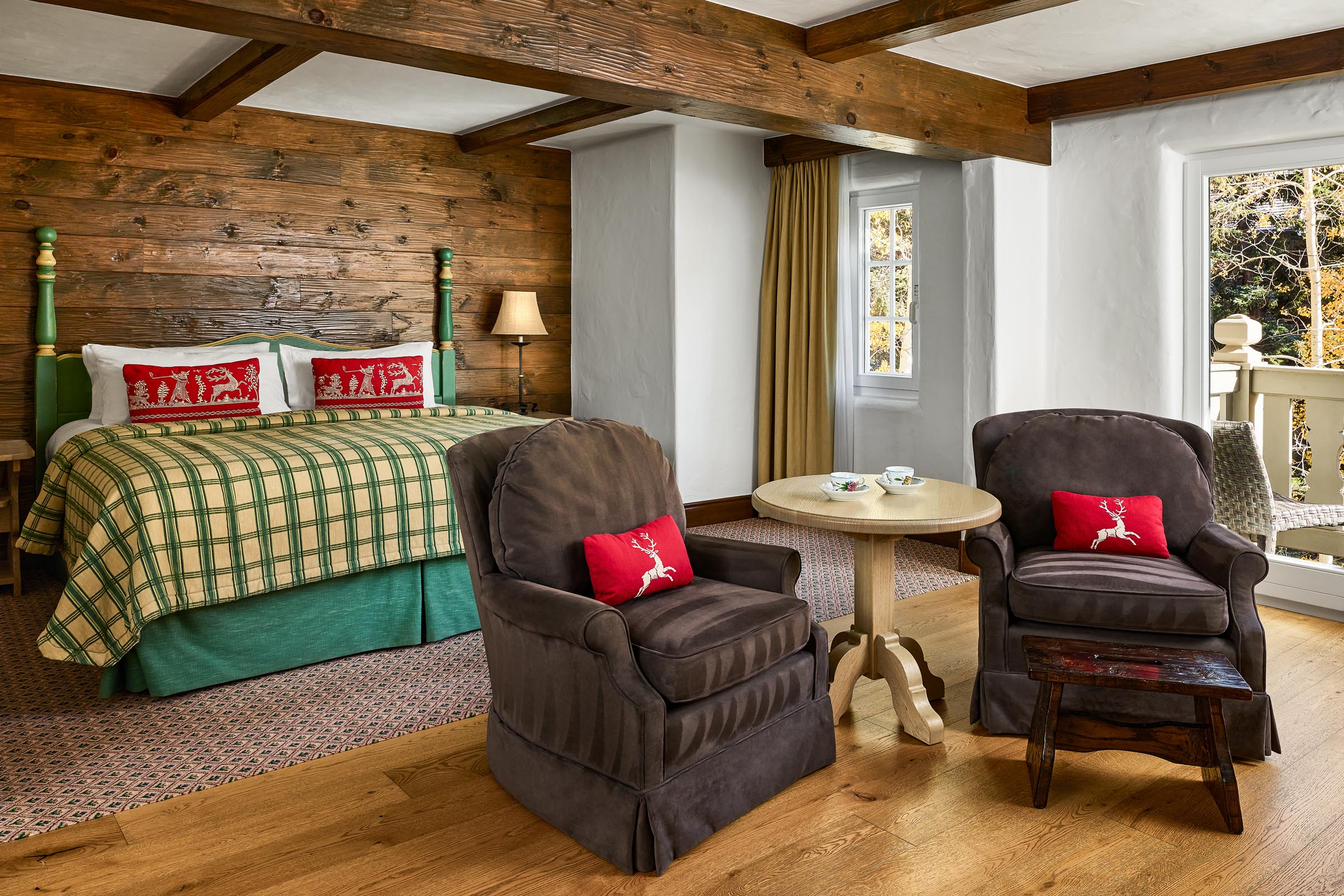 Suite with living room, fireplace, sofa, chairs, and armoire