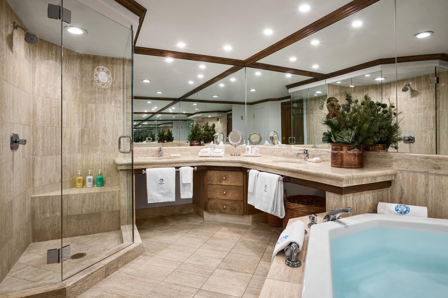 large bathroom with soaking tub, double sink, and showe with glass doors