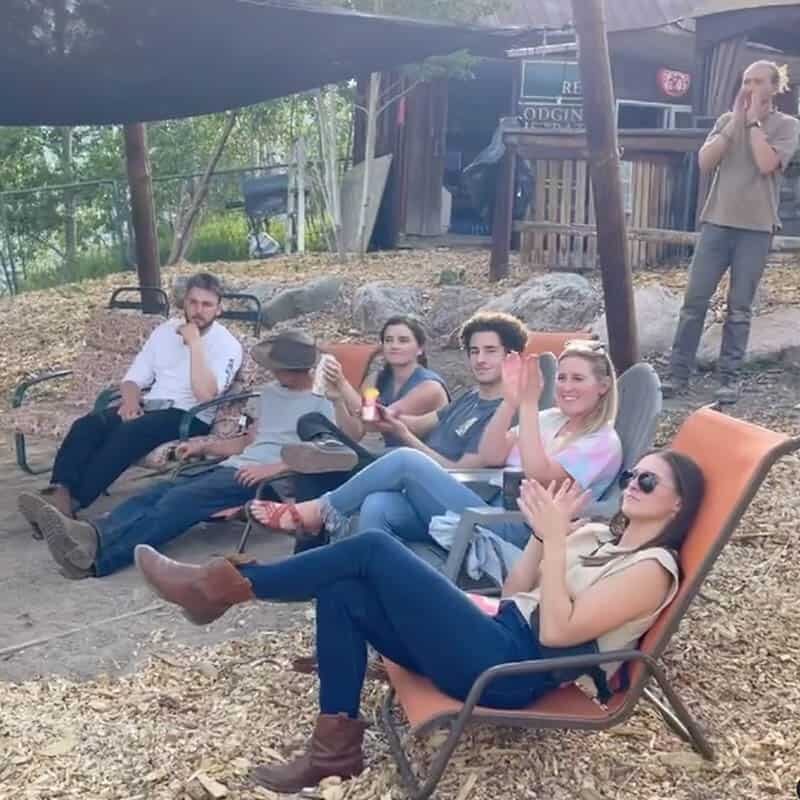 Girls and boys clapping looking a horseback riding