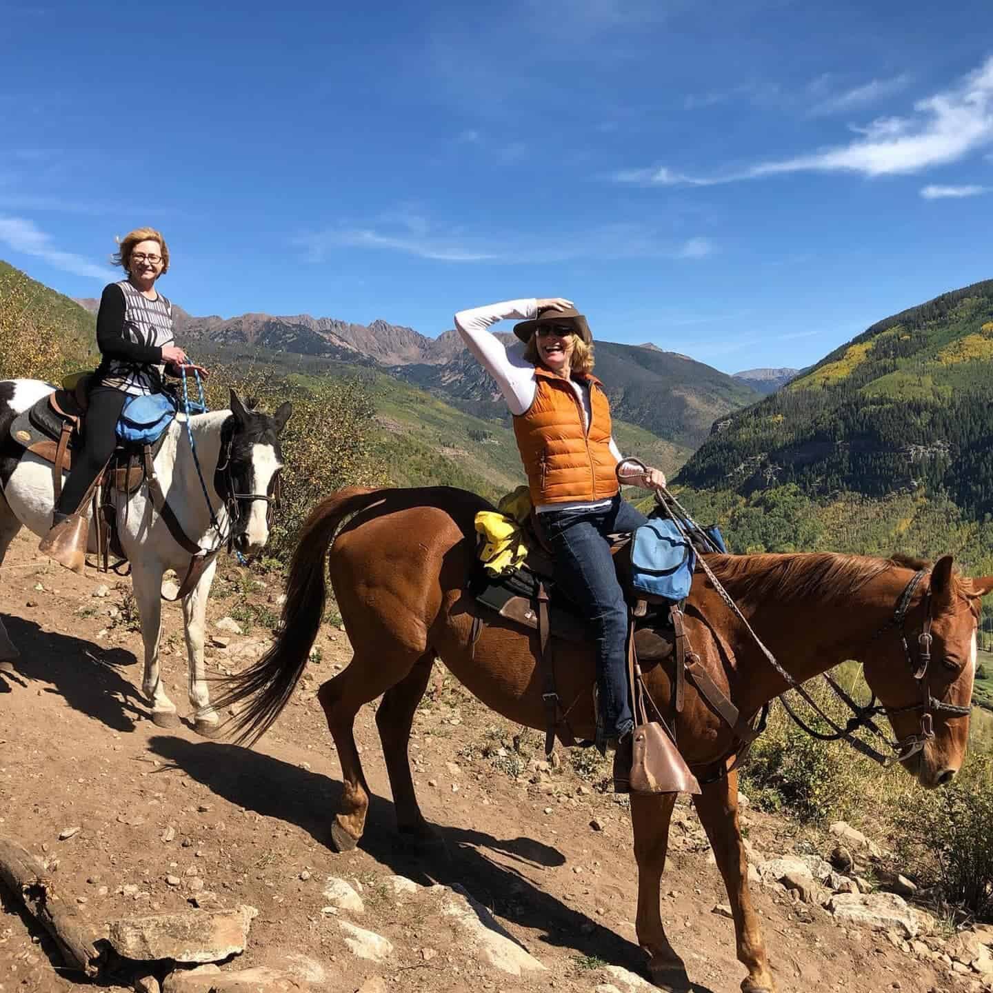 two women riding a horse