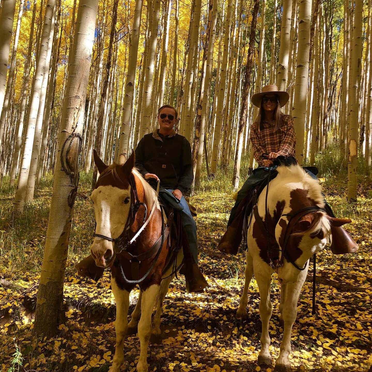 A couple riding horses in Vail Colorado