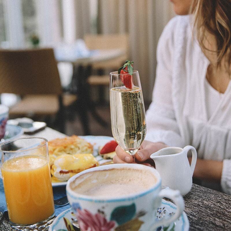 Mother enjoying a mimosa and brunch at Sonnenalp Hotel's Mother's Day Brunch