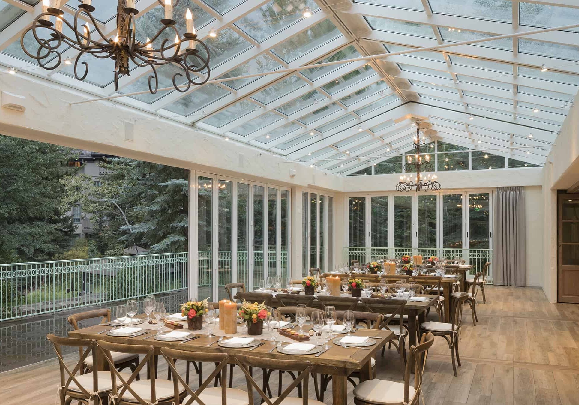 Outdoor terrace with glass roof, and tables wth placesettings