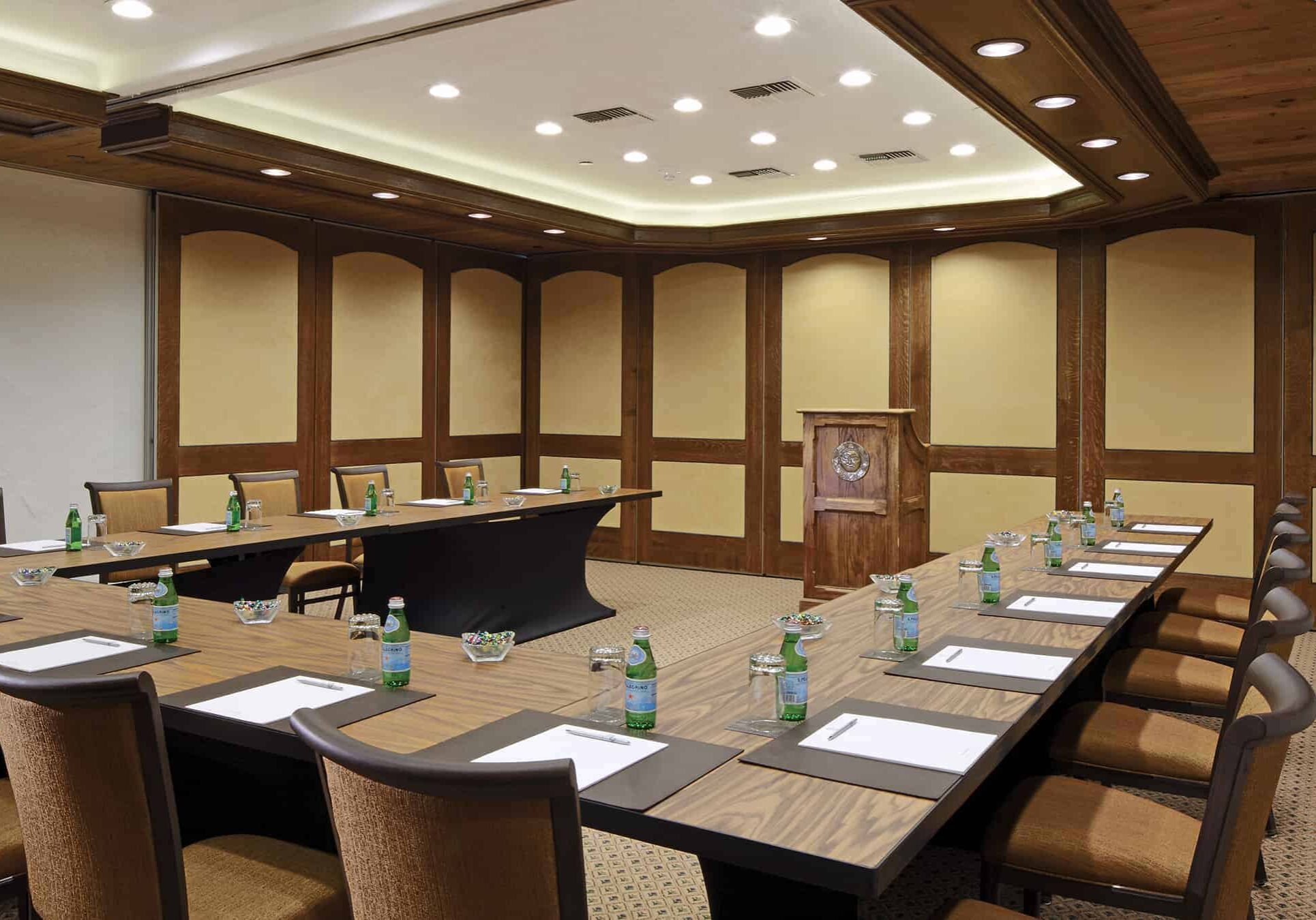 Meeting room with horseshoe table and podium in the background