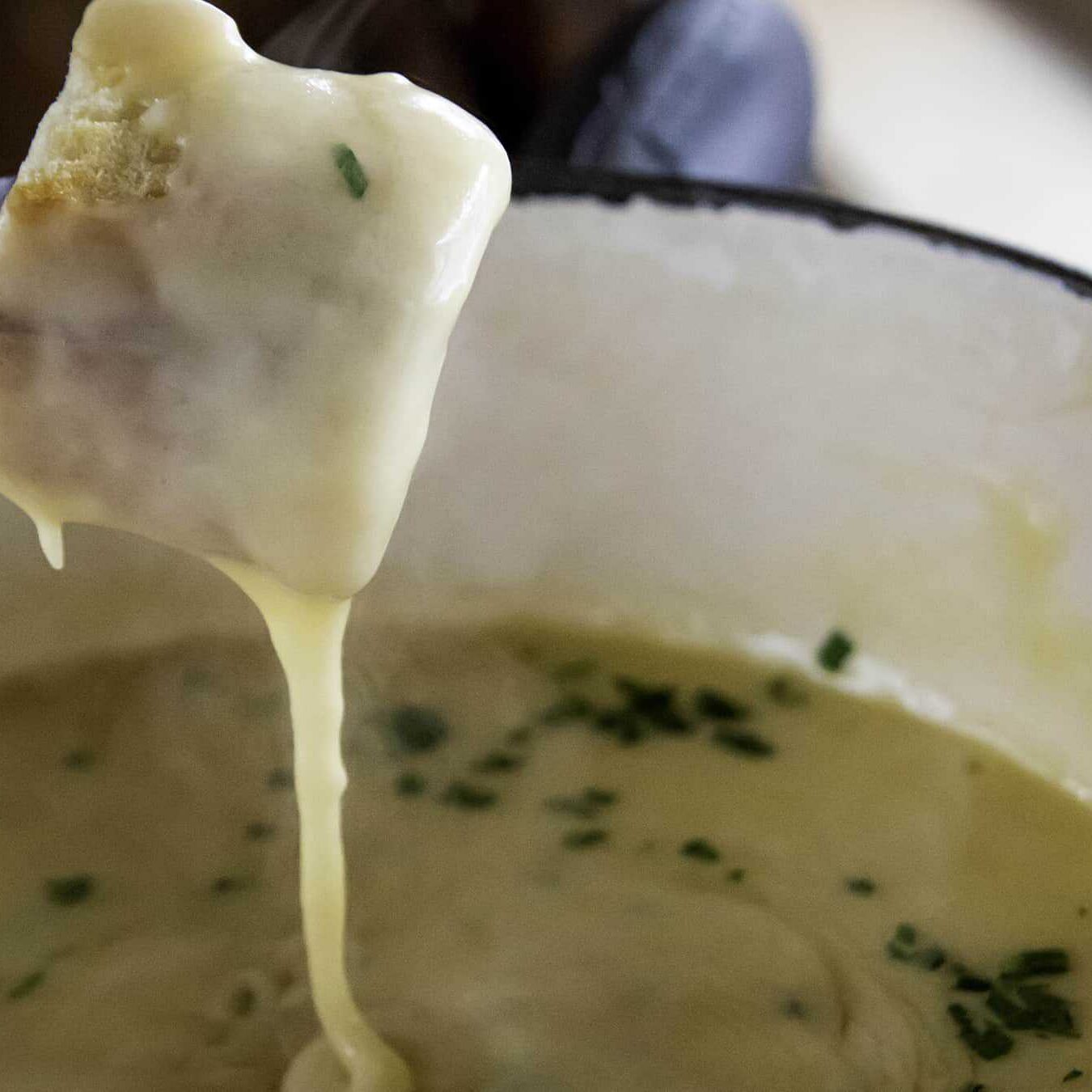 Closeup of bread over fondue pot