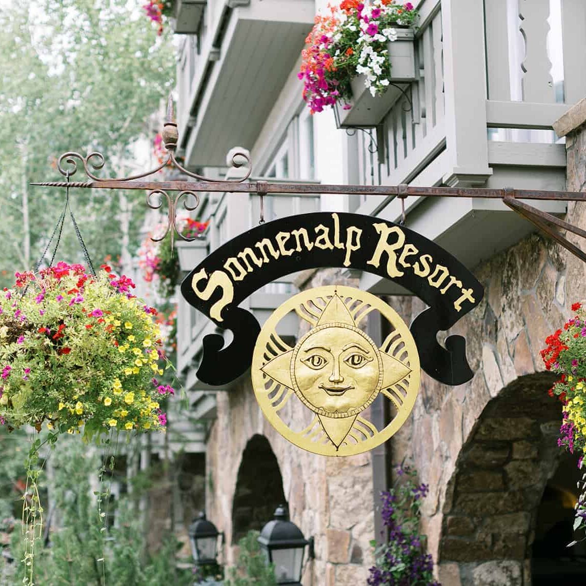 Exterior of Sonnenalp Hotel and signage that reads Sonnenalp Resort