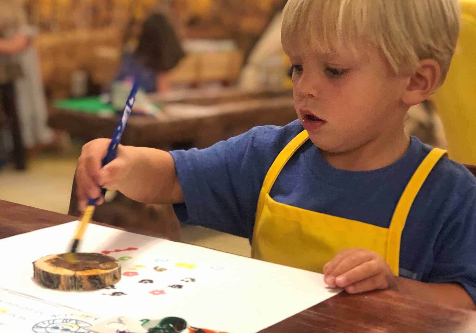 Child painting with brush