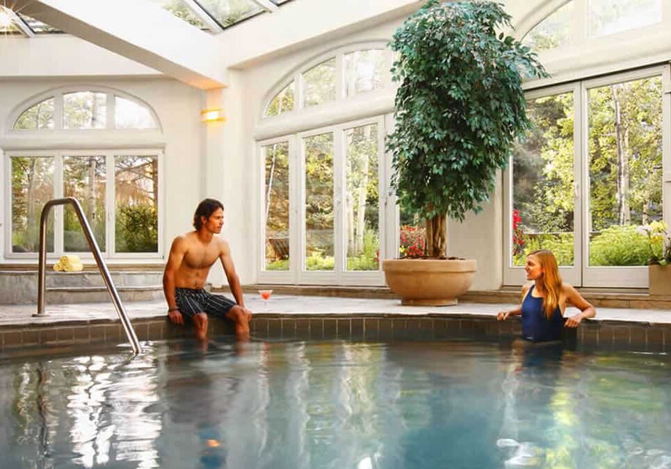 Couple having a good time at the indoor pool Sonnenalp