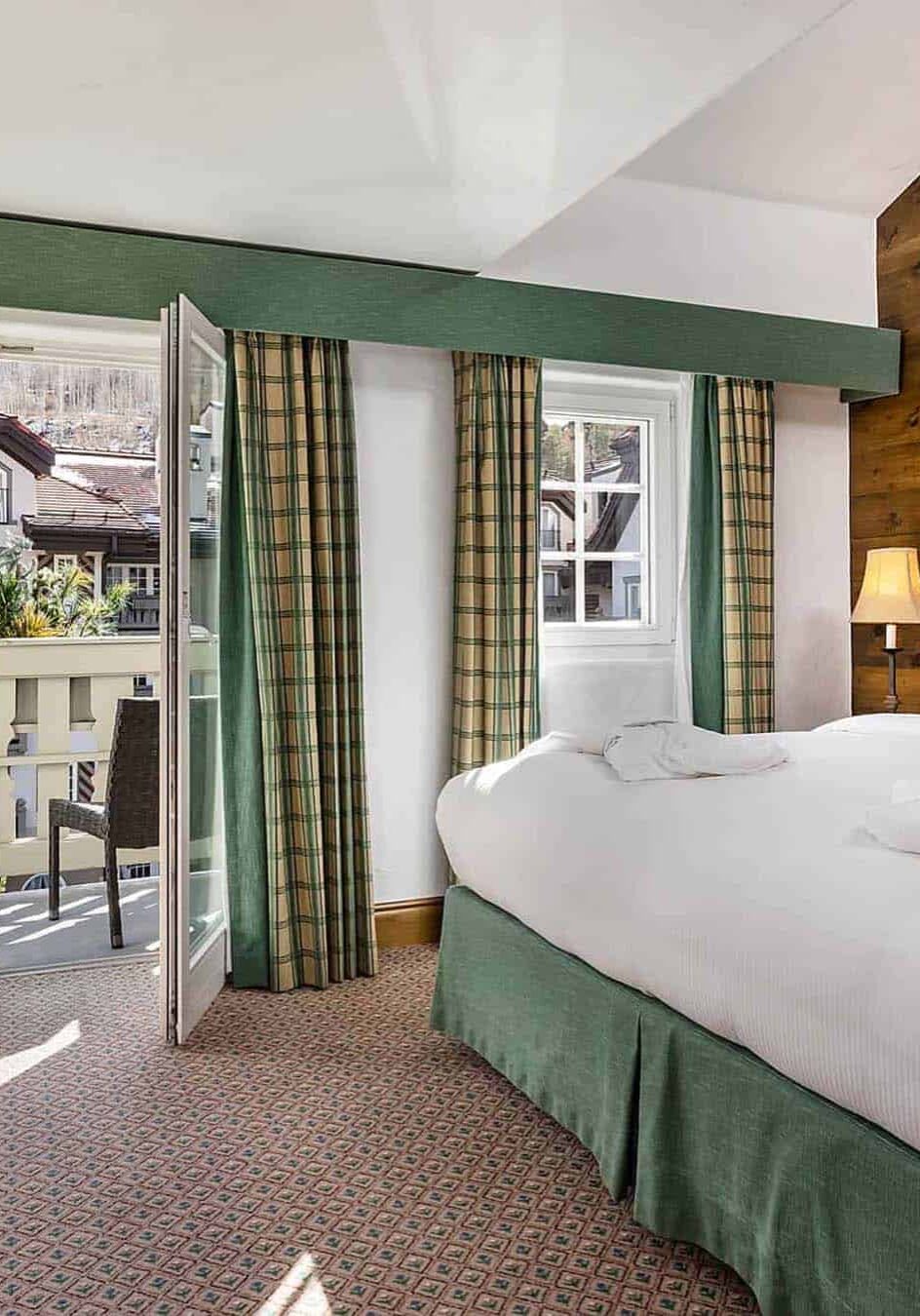 Bed in white sheets and red pillows