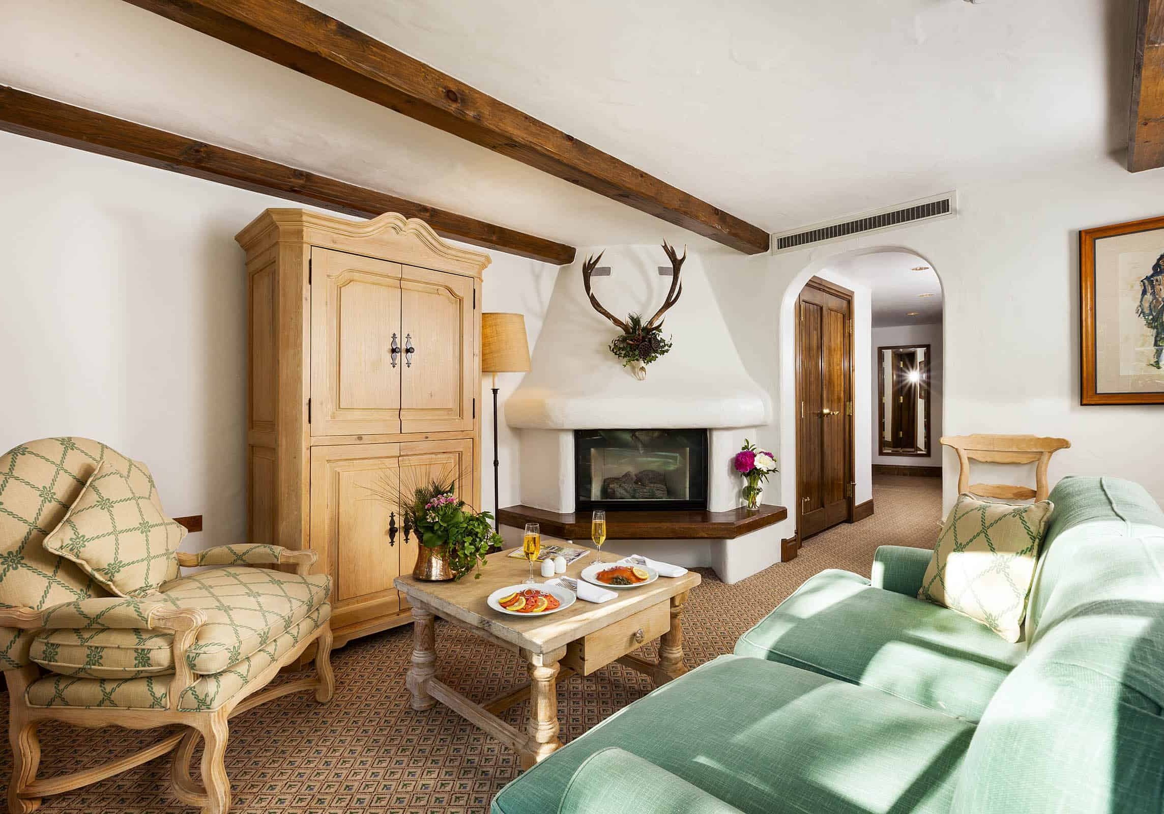 living room area with sofa, chair, coffee table, fireplace, and dresser